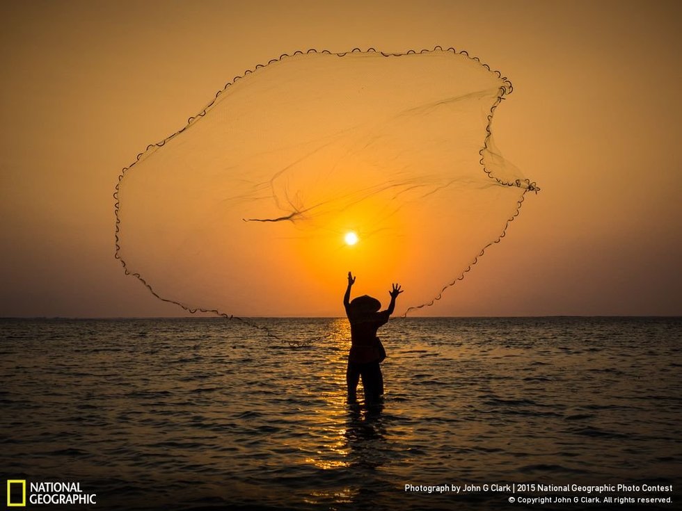 Casting a wide net...The photographer, John G Clark, says: "A fisherman in Bali casts his net at sunrise, hoping for a good catch."