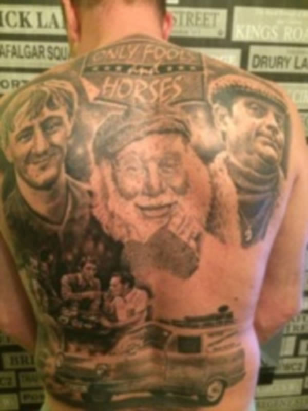 An Only Fools and Horses superfan has spent 50 hours under the tattooist's needle getting a giant mural of his favorite show etched onto his back. Bristol resident Darren Williams spent £4,000 ($6,000) and two months in the tattoo parlor perfecting the tribute that comes complete with Del Boy, Rodney, Uncle Albert, Trigger, Boycie, and Nelson Mandela House.

The giant back piece even features the iconic yellow Reliant Regal van driven by Del and Rodney, played by David Jason and Nicholas Lyndhurst. Williams, 47, underwent ten painful five-hour sessions to have the tattoo emblazoned on his back and even canceled a planned holiday to Barbados so that it could be completed. Despite his extreme tribute to the show, Williams insists he is not "fanatical" and "just liked the design."