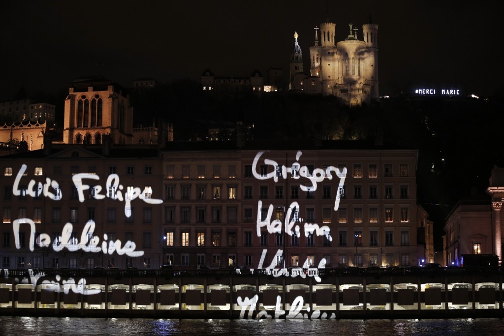 The first names of the 130 Paris attacks victims are spread over buildings in Lyon, France, following the cancellation of the Festival des Lumieres to express solidarity with the victims.