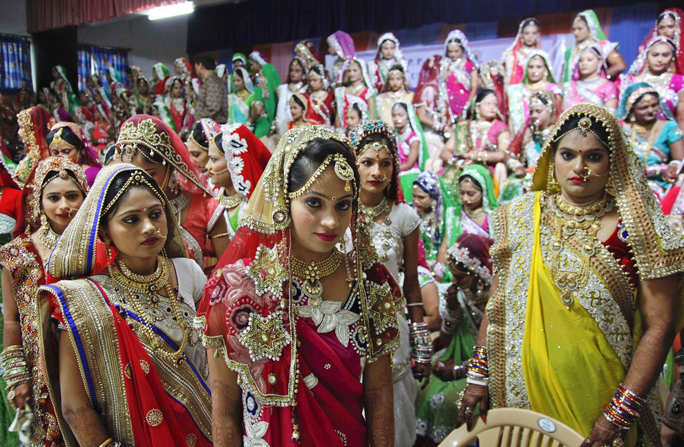151 Indian brides pose at a mass wedding in Surat, India. Weddings are so expensive in the country that they're often done in mass.