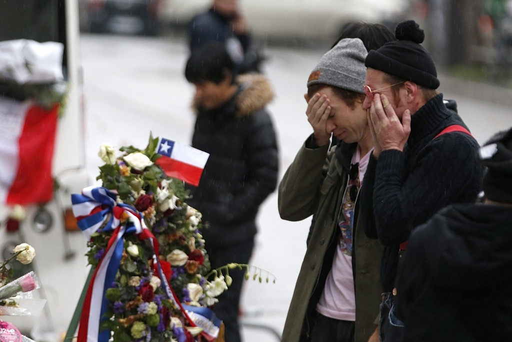 Jesse Hughes and Julian Dorio,  members of Eagles of Death Metal band who were playing in the Bataclan at the time of the Paris attacks, pay tribute outside the concert hall.