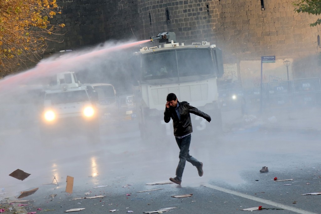 Riot police use a water cannon to disperse demonstrators during a protest in the Kurdish dominated city of Diyarbakir, Turkey.