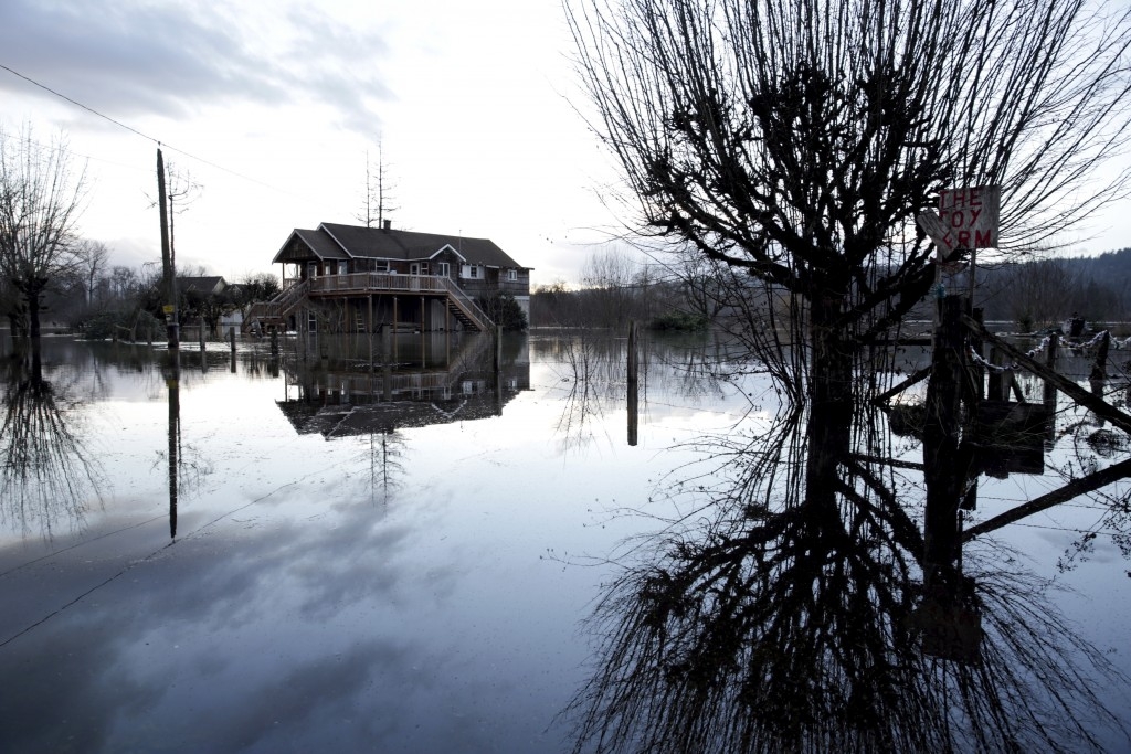 . Flood waters of the Snoqualmie River surround a home during a storm in Carnation, Washington.