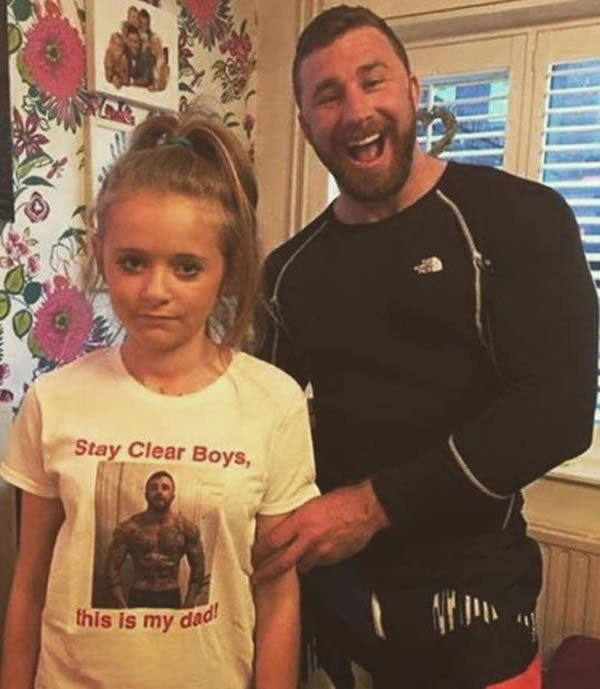 This picture was shared by Kit Dale, two-time World Pro Brazilian Jiu-Jitsu champion, to his more than 90,000 followers via #thefatjewish. The photo depicts a very physically fit dad and a very disgruntled daughter. On the front of the girl's shirt is a picture of her father, ripped and flexing. The homemade shirt reads: “Stay Clear Boys, this is my dad!”