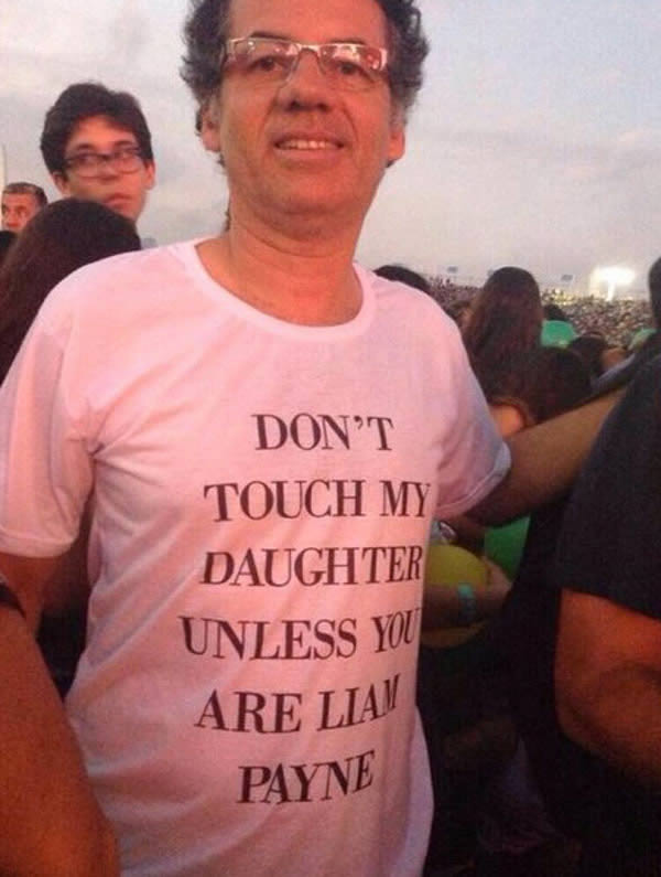 A One Direction fan's dad wearing a funny t-shirt at their concert.