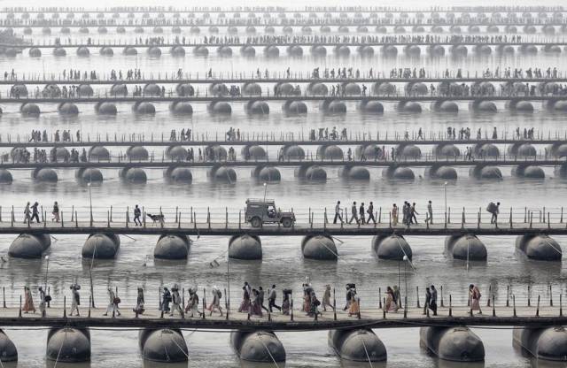 People crossing bridges in India at the Maha Kumbh Mela