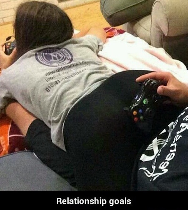 Funny picture of relationship goals of girl and guy playing video game in a position which allows him to rest on her butt