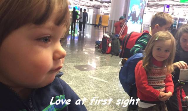 little girl looking at boy airport - Love at first sight