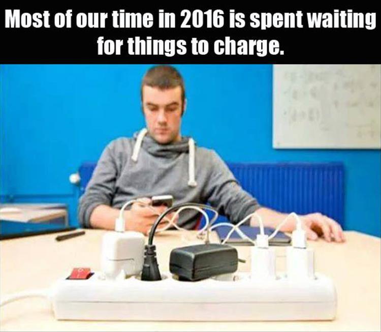 man charging phone - Most of our time in 2016 is spent waiting for things to charge.