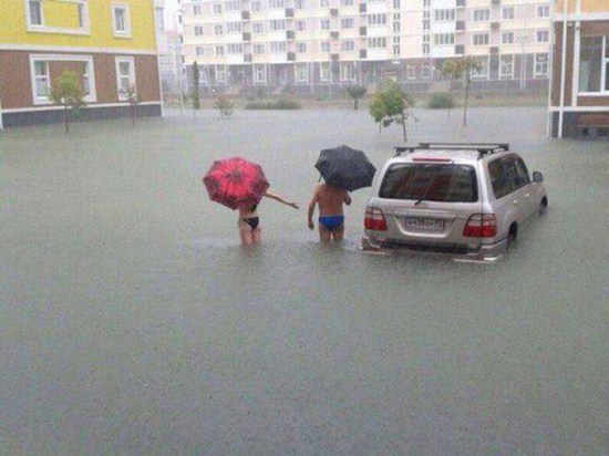 flooded road a couple walking through it