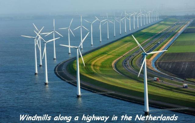 modern dykes windmills and highways in the netherlands - Windmills along a highway in the Netherlands