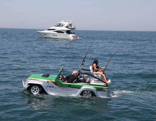car in ocean and people fishing in it