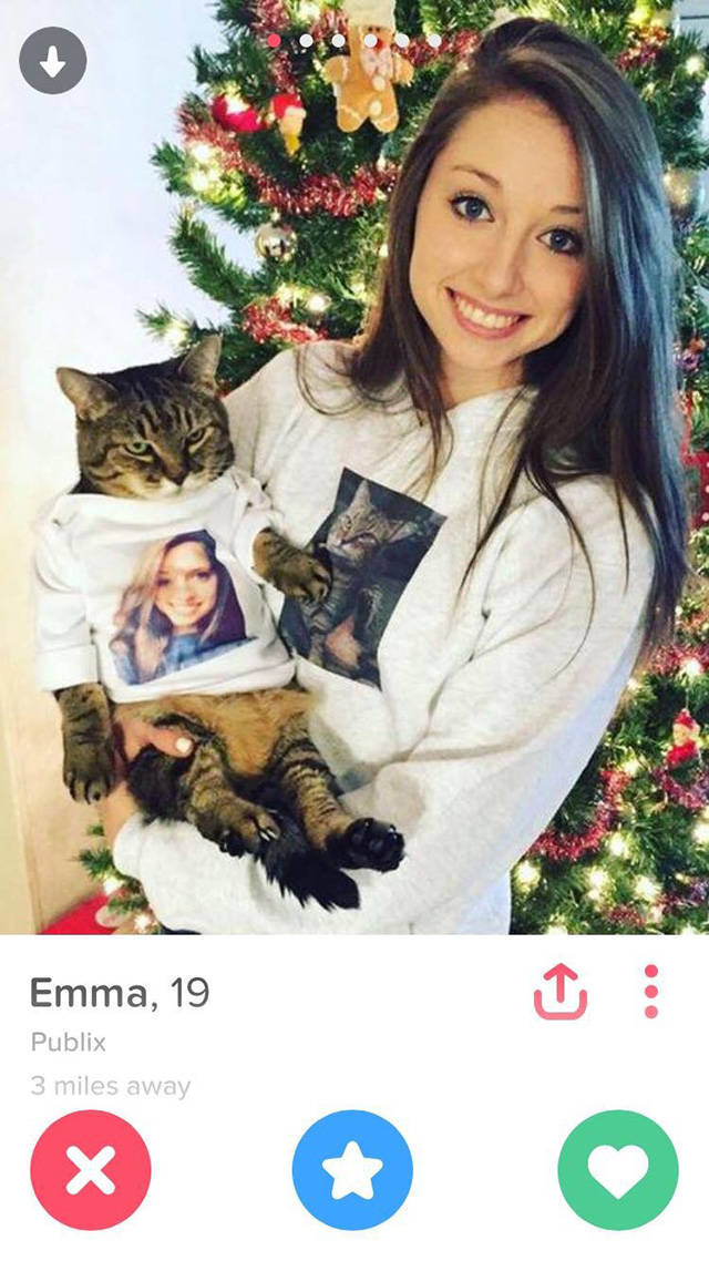 Woman with her cat and matching t-shirts with each other's pictures.