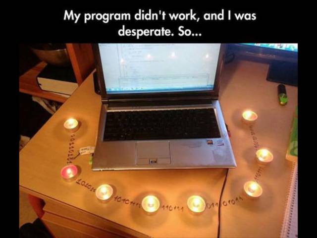 Funny meme of a man performing some kind of candle lit vigil to fix his computer.