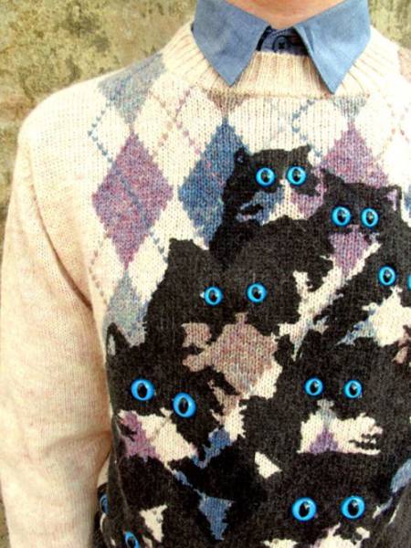 Sweater with many cats and eyes that tick out.