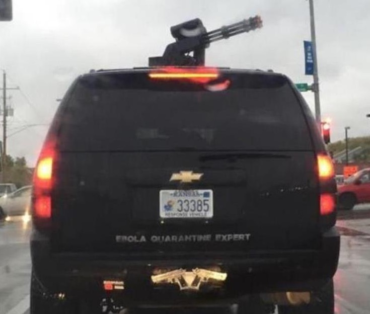 Funny picture of a person who installed what look like a Vulcan Gatling gun on the roof top of his SUV.