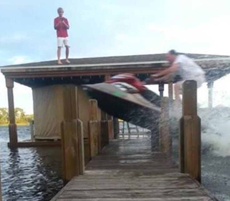 Funny picture of a dude jumping the dock on his jet ski