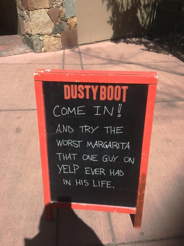 Funny picture of a chalkboard outside a bar inviting you to come in and try that Margarita that one dude said was the worst he ever had on Yelp.
