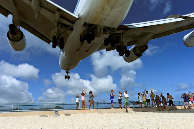 plane landing close to beach