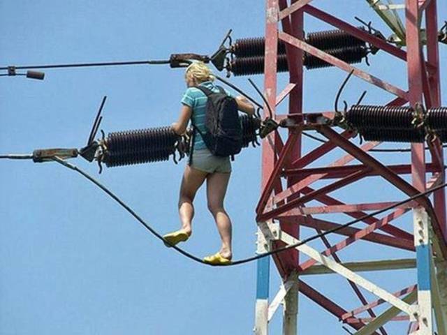 stupidity climbing electric pylon