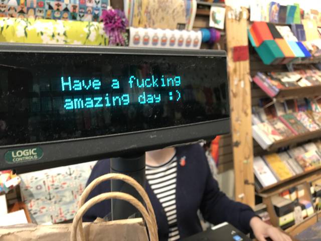 Cash register with very enthusiastic message.