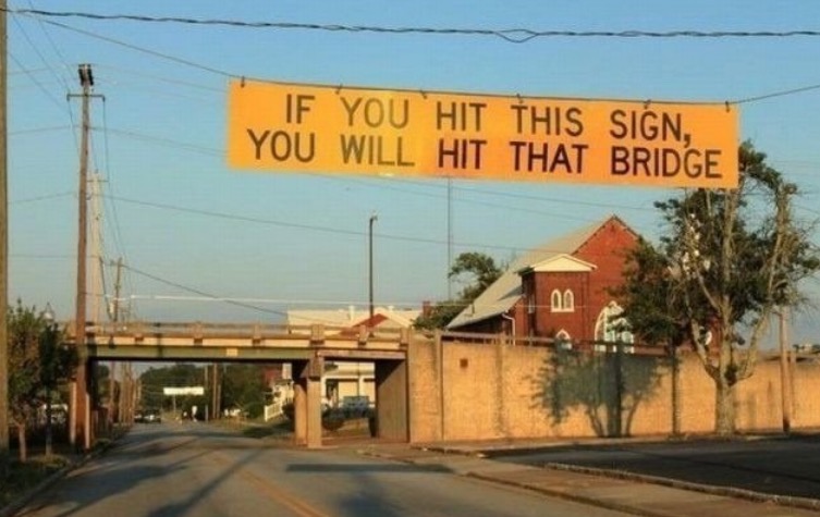 Sign telling you that if you hit it, then that bridge is too low for you.