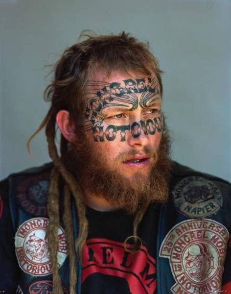Man with tattos on his face and a beard