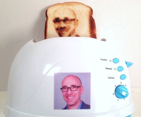 Toaster that burns faces into the slice, with example printed out.