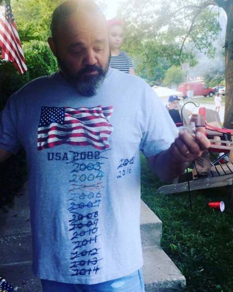 Man with a shirt that said USA 2002 that has been crossed out and updated every year till 2016