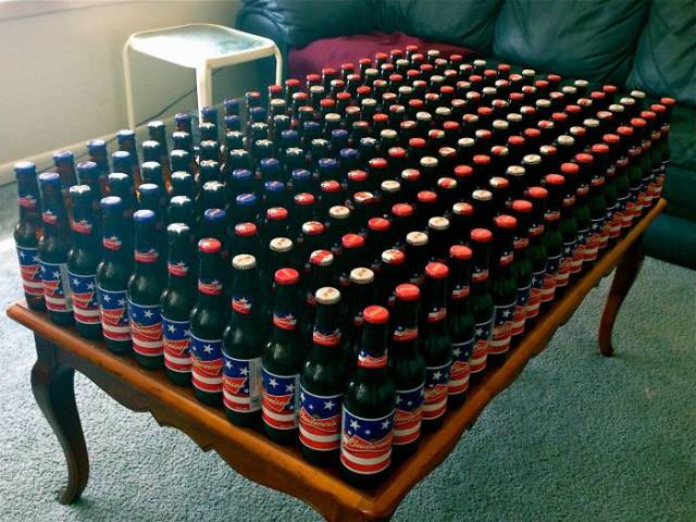 Beer bottles arranged so that they resemble the pattern outline of the American flag.