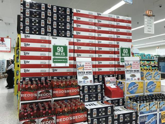 Display of beer cases that is configured to look like the American flag.