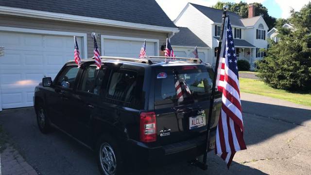 Jeep decked out with like 7 flags.