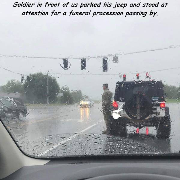 soldier salutes funeral - Soldier in front of us parked his jeep and stood at attention for a funeral procession passing by.