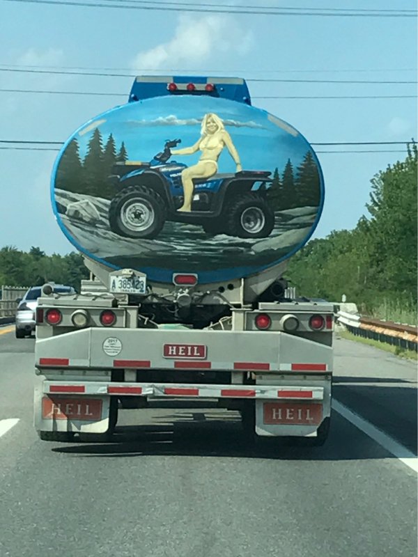 Airbrush of a woman on a quad bike on the back of a trailer semi tanker