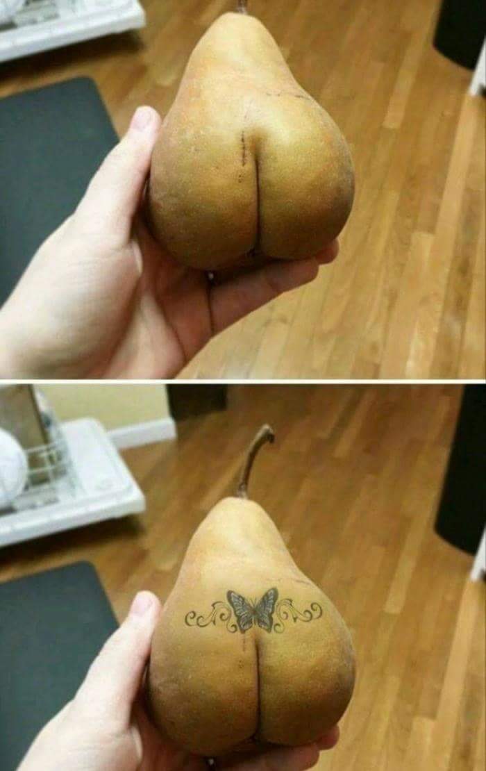 Funny pear that looks like a butt on which someone drew a cliche butterfly tramp stamp tattoo