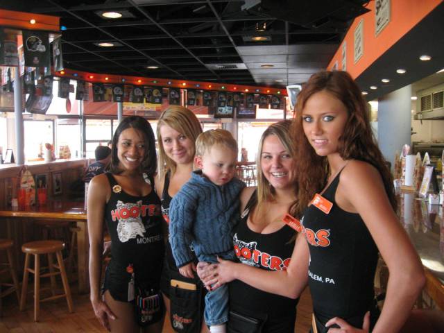 hooters girl holding a toddler