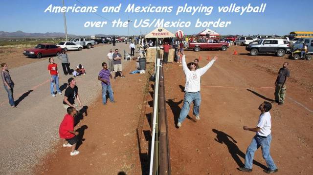 americans and mexicans - Americans and Mexicans playing volleyball over the UsMexico border