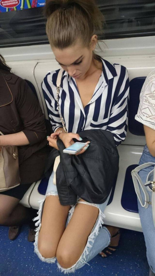 Hot girl on public transport with jeans torn exposing her legs.