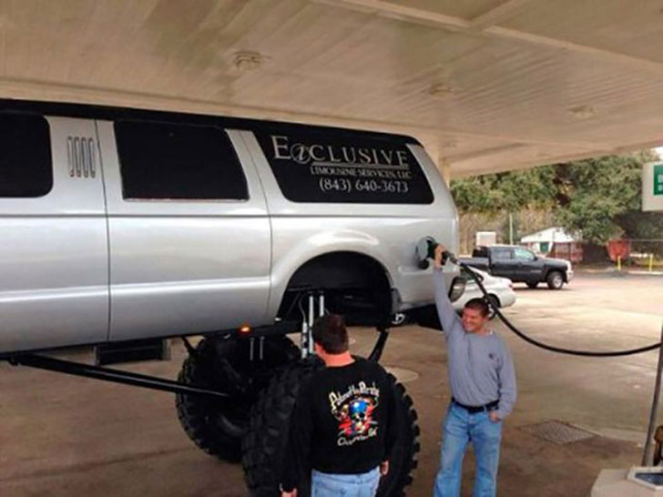 Monster Truck limousine service, filling up with gas holding the pump over his head.