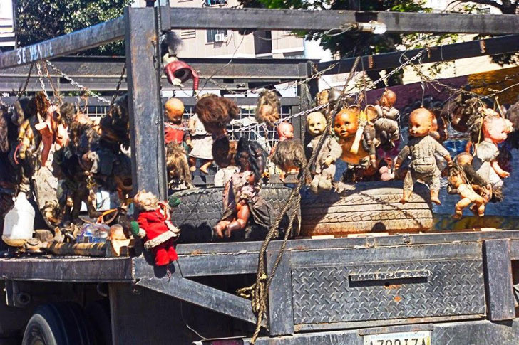 Creepy truck with dolls strung up all over the place.