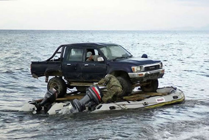 Pickup truck on a floating platform atop to inflatable rafts