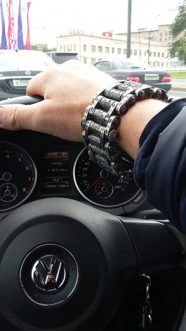Driver wearing motorcycle chain wrist band.
