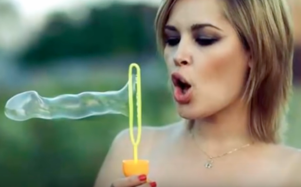 woman blowing a bubble that has the distinct shape of a penis