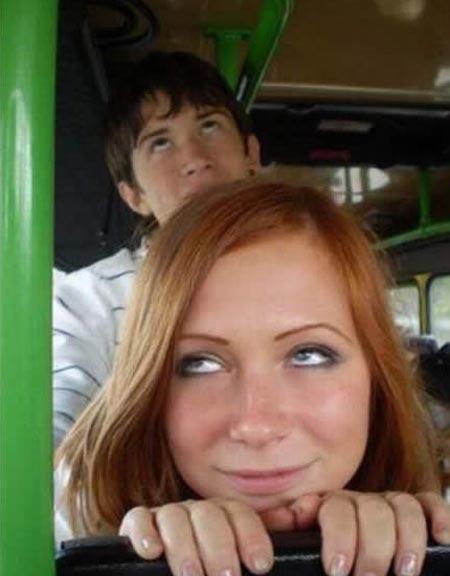 Teens posing on a bus in an obscene way.