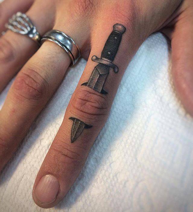 knife on finger tattoo