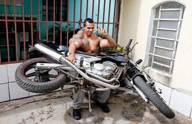 man holding a motorcycle