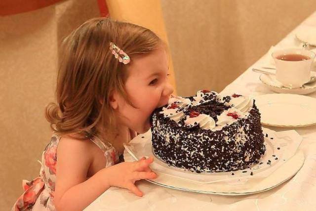 random little girl eating cake