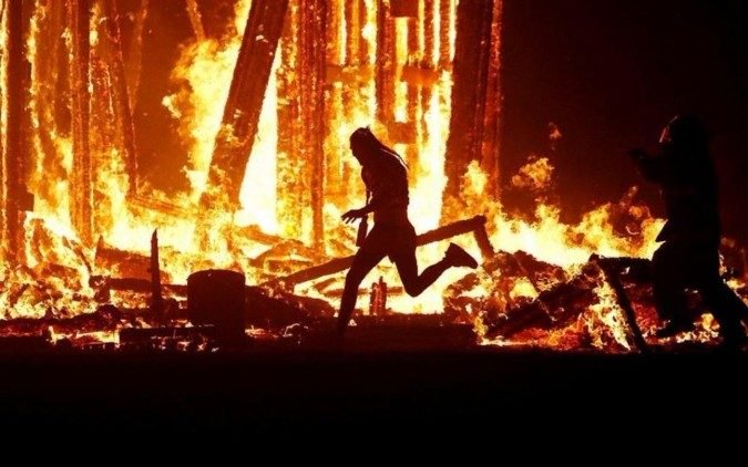 burning man jumps in fire