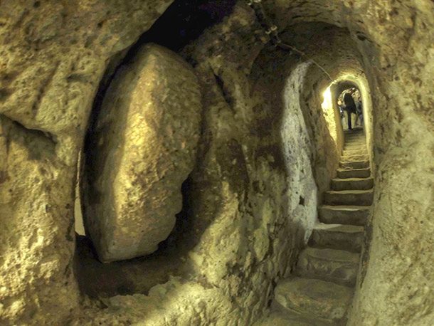 Derinkuyu Underground City is an ancient and complex underground city underneath modern-day Turkey. The tunnels are full of dwellings and homes and could house up to 20,000 people if they needed to. The city reaches around 250 feet deep (76 m). No one knows how old it is or what civilization originally built it.