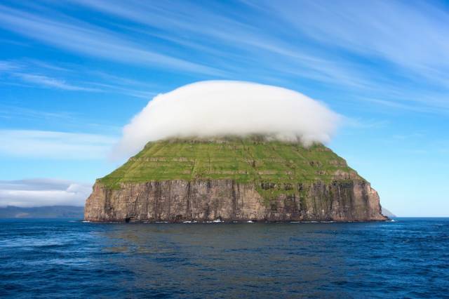This tiny island (.32 sq miles) is called Lítla Dímun, and is located in the Faroe Islands.
